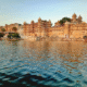 Lake Pichola in Udaipur with calm waters, historic palaces, and surrounding Aravalli h