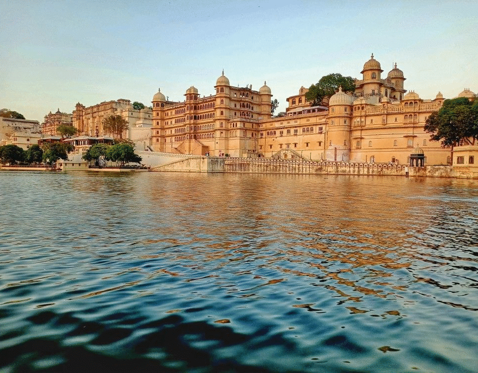 Lake Pichola in Udaipur with calm waters, historic palaces, and surrounding Aravalli h
